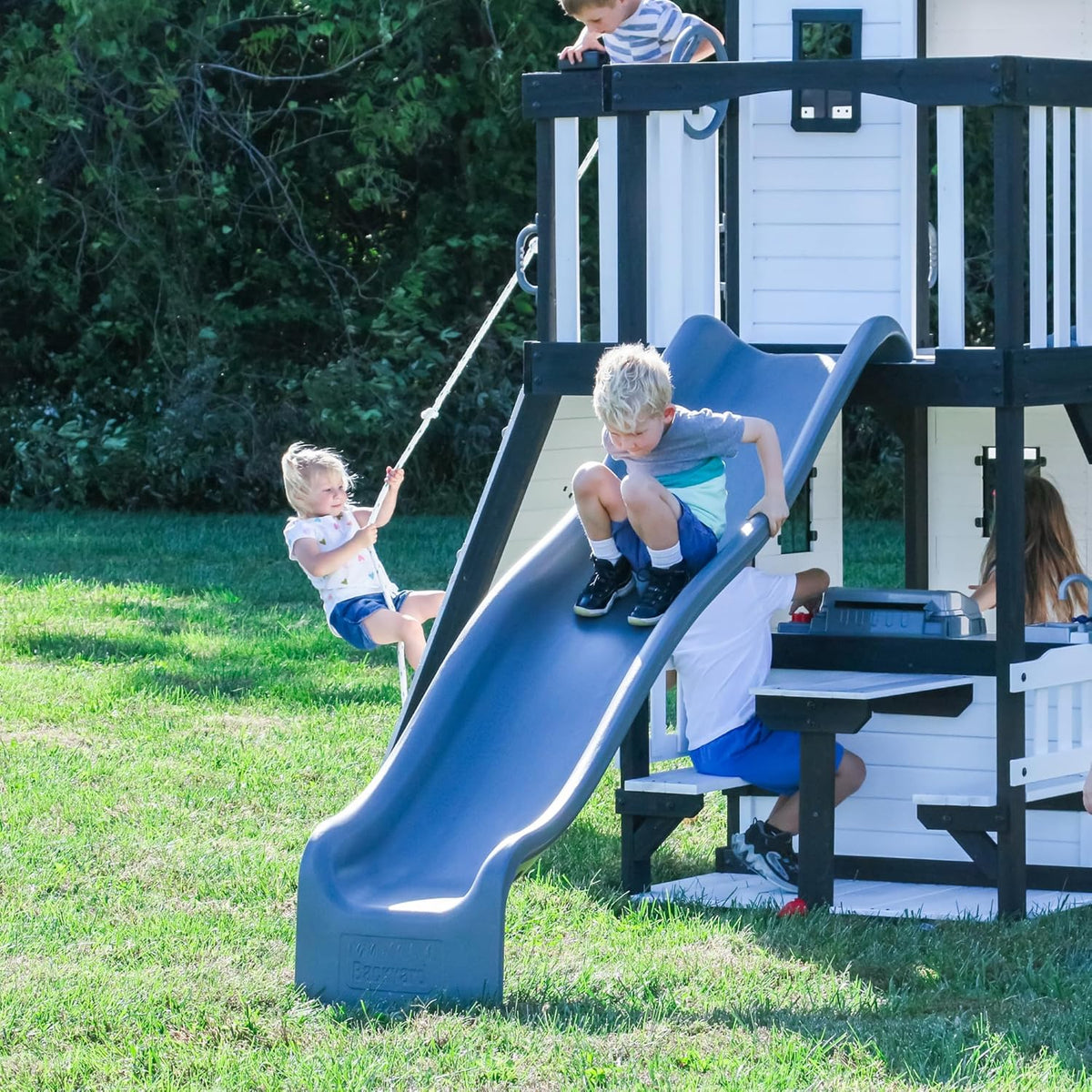 Backyard Discovery Canyon Creek Cedar Wood Swing Set with Wave Slide, Clubhouse, Play Kitchen, Picnic Area, Belt Swings, Web Swing, Rock Wall, Balconies, Playhouse, Step Ladder, Outdoor Playset